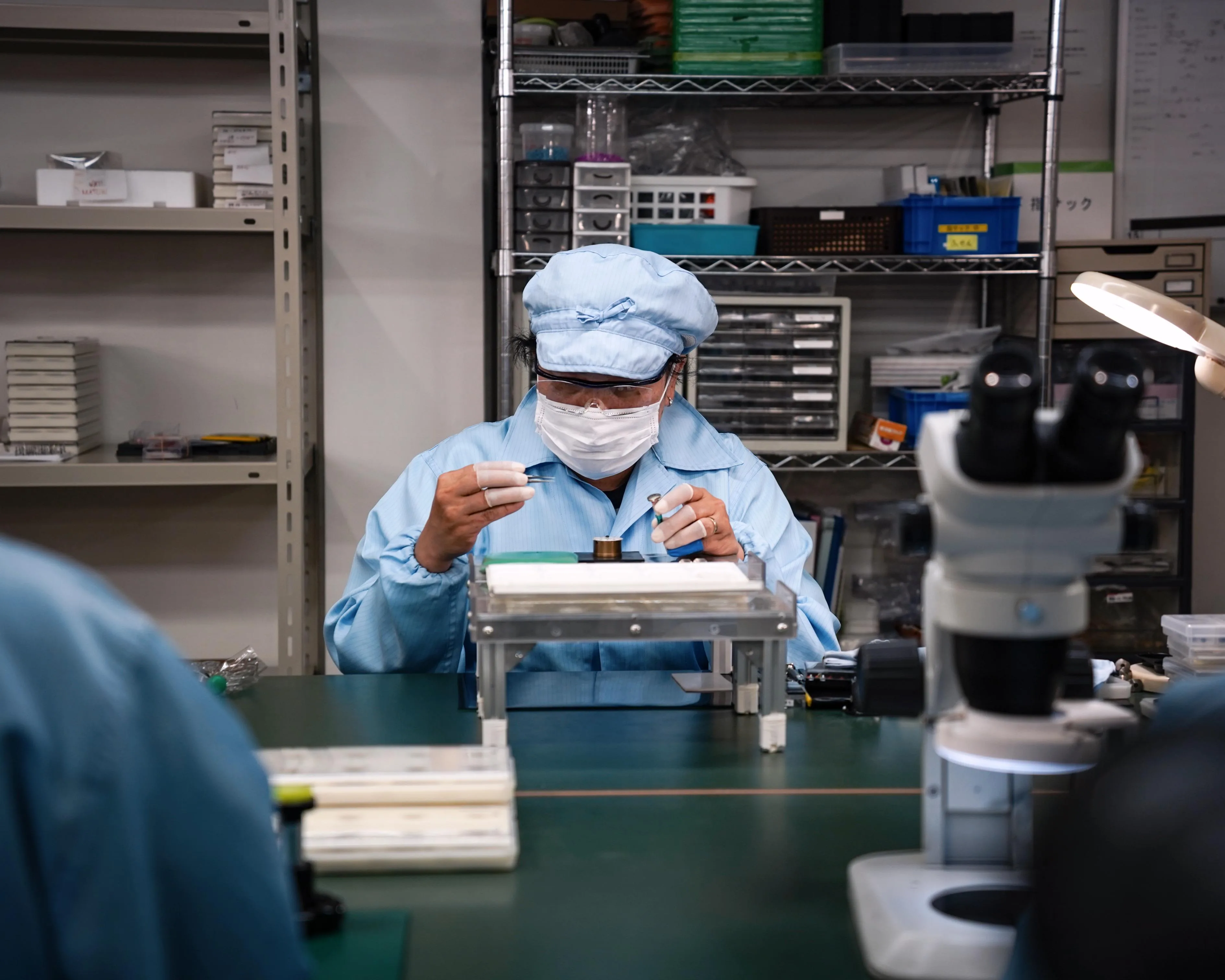 A Hitori watchmaker assembling a dial at the bench